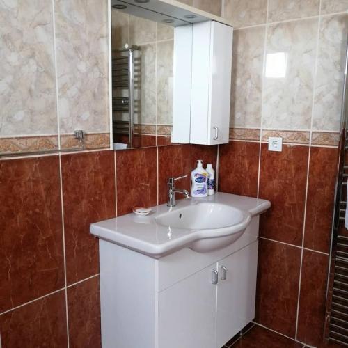 a bathroom with a white sink and a mirror at Villa Latanya in Dalaman