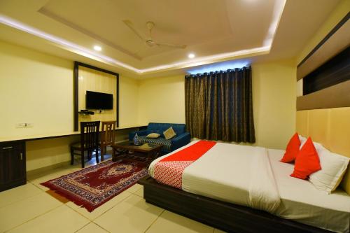 a bedroom with a bed and a living room at Collection O Tip Top in Jaipur