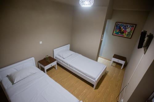 a small room with two beds and a table at Cavallari Palace Hotel Suites in Athens