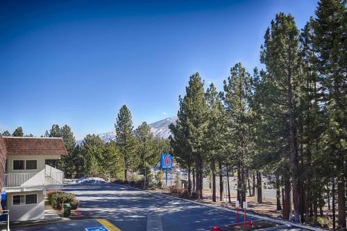 an empty street with trees on the side of a road at Motel 6-Mammoth Lakes, CA in Mammoth Lakes