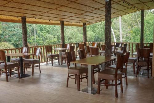 a row of tables and chairs on a patio at RedDoorz near Londa Toraja in Madandan
