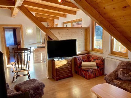 a living room with a large flat screen tv at Appartement Mittagskogel in Velden am Wörthersee