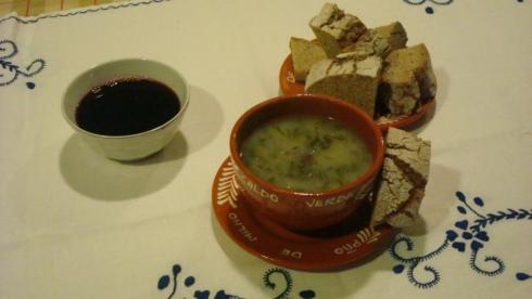 a plate of food with a bowl of soup and crackers at Quinta do Rio Homem in Caldelas