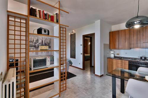 a kitchen with a table and a microwave in a room at Belvedere Beatrice - Rebomaholidays in Olzano