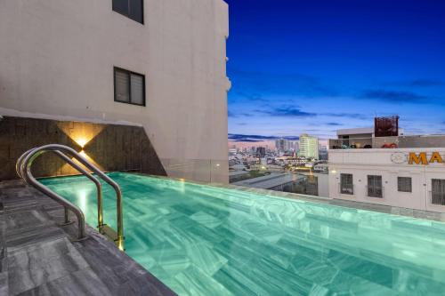 a swimming pool on the roof of a building with a view at Lagom Boutique Hotel Da Nang in Da Nang