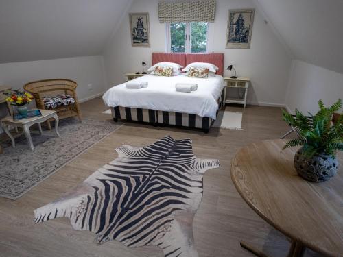 Schlafzimmer mit Zebra-Teppich auf dem Boden in der Unterkunft Taunton in Port Elizabeth