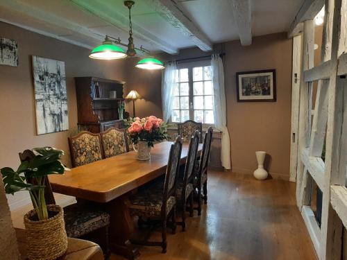 a dining room with a wooden table and chairs at Dock 23 in Colmar