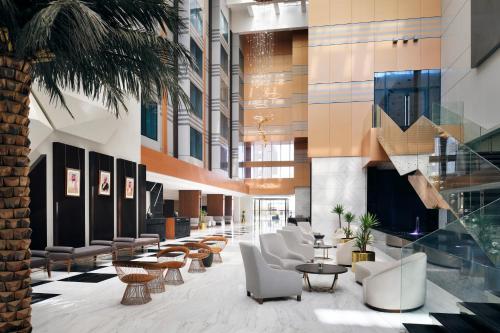 a lobby of a building with chairs and tables at Crowne Plaza Hotel Riyadh Minhal, an IHG Hotel in Riyadh