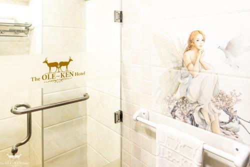 a bathroom with a sticker of an angel on the wall at The Ole-Ken Hotel in Nakuru