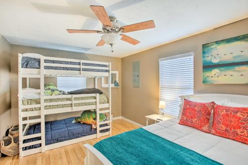 a bedroom with two bunk beds and a ceiling fan at Welcoming Byrdstown Home Walk to Main St! in Byrdstown