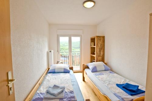 2 camas en una habitación con ventana en Gasthof Hirsch, en Waldstetten