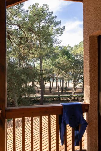 a view from the balcony of a porch with trees at Résidence Hôtelière les Acanthes in Hossegor