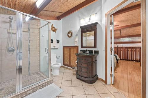 a bathroom with a shower and a sink and a toilet at Oceanside-Spectacular View and Poolside Oasis in Kahana