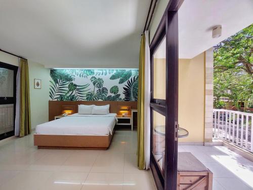 a bedroom with a bed and a balcony at Shinta Guesthouse in Malang