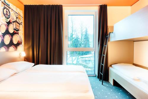 Postel nebo postele na pokoji v ubytování B&B Hotel Bamberg