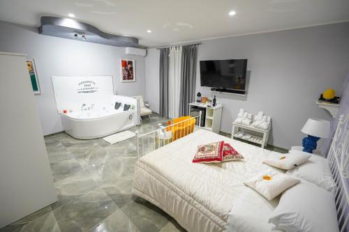 a bathroom with a bed and a bath tub and a sink at Piedigrotta Magique Luxury in Pizzo