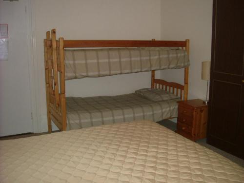 a bedroom with two bunk beds and a bed at Thalatta Guest House in St. Clements