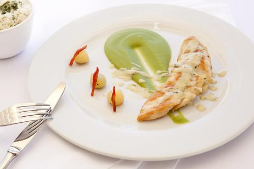 a plate of food with fish and vegetables on it at Aranwa Pueblito Encantado del Colca in Coporaque