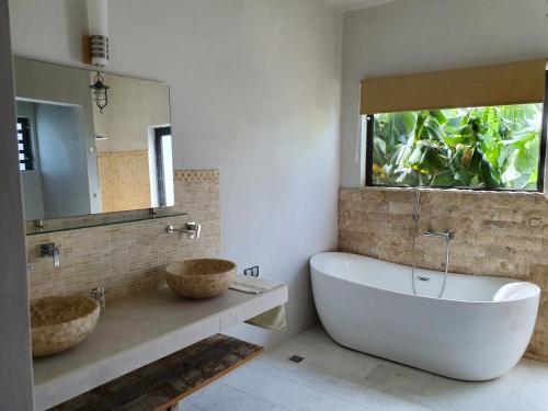 a bathroom with a tub and a sink and a mirror at Stunning and Luxurious Villa at Royal Park Balaclava in Balaclava