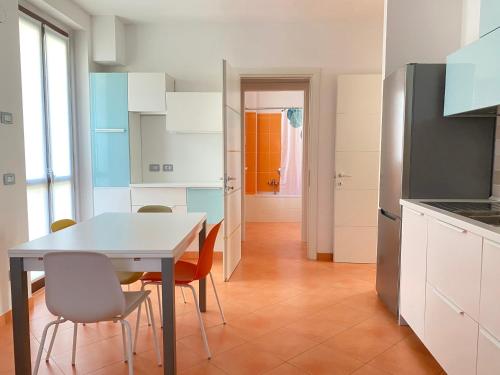 a kitchen with a table and chairs in a room at Adamo ed Eva Resort in Numana