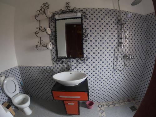 a bathroom with a sink and a mirror at Citadelle Gorges in Ait Ben Ali