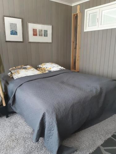 een slaapkamer met een groot bed in een kamer bij Alapihan Arboretumin vierasmaja ja sauna 
