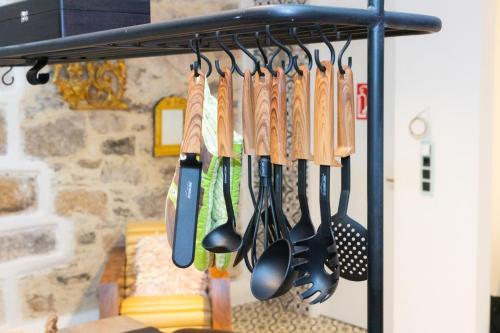 a bunch of utensils hanging from a rack at Holzwerk Oybin in Kurort Oybin