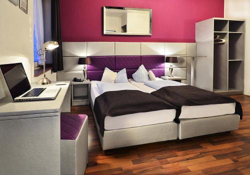 Кровать или кровати в номере Hotel Am Wehrhahn