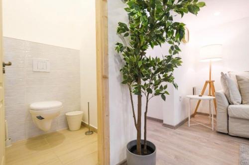 a living room with a toilet and a tree in it at 2 bedroom flat in Nyar str., Boutique in Budapest