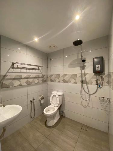 a bathroom with a shower and a toilet and a sink at CT HOME83Stay - Klebang Beach Melaka in Kelebang Besar