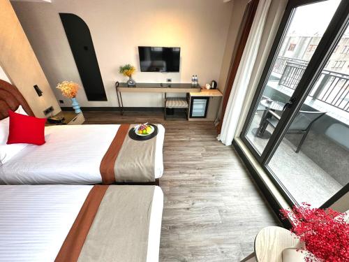 a hotel room with a bed and a desk with a television at Edition Old City Hotel in Istanbul