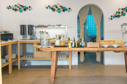 a kitchen with a wooden table with drinks on it at Hotel d'Or in Cala d´Or