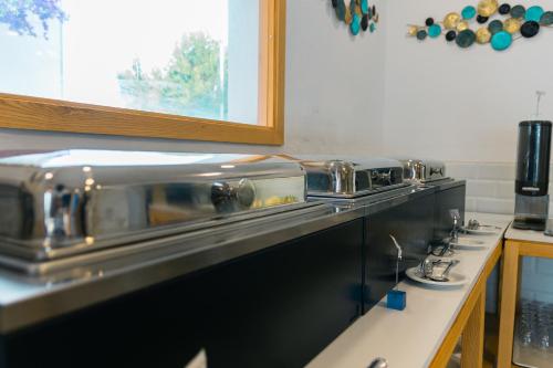 a kitchen with a counter with several pots and pans at Hotel d'Or in Cala d´Or