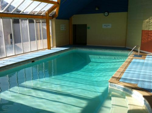 a large swimming pool with an empty at Thistle Lodges at Sandyhills Bay in Dalbeattie