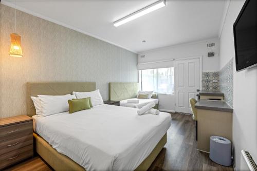 Ένα ή περισσότερα κρεβάτια σε δωμάτιο στο Rosebud Motel