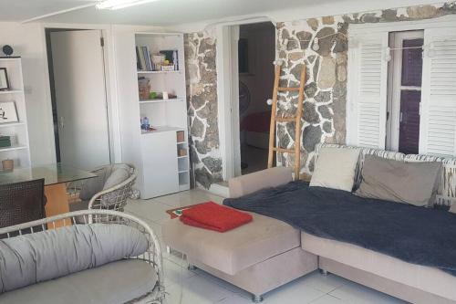 a living room with a bed and a couch at High By The Beach House in Girne in Ayyorgi