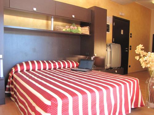 a bedroom with a bed with a laptop on it at Hotel Iacone in Chieti