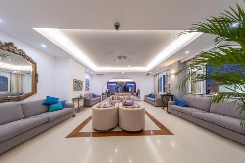 a living room with couches and a table at Glaros Beach Hotel in Hersonissos