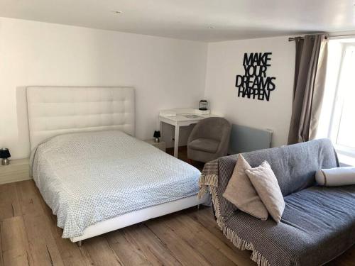 une chambre avec un lit, un canapé et un bureau dans l'établissement Appart 2 pièces 35m2,centre ville, parking gratuit, à Bourges