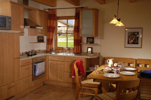 a kitchen with a table and a dining room at Ferienhaus Lenzenbauer in Salzburg