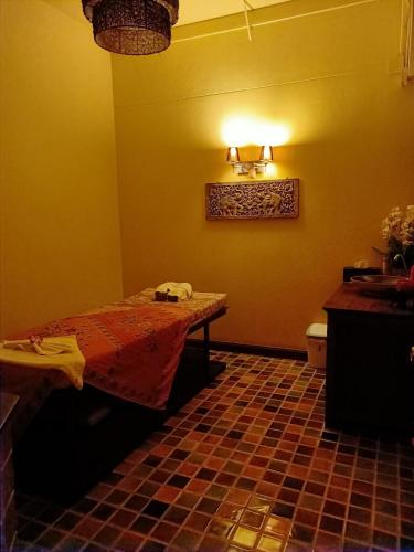 a room with a bed and a table in a bathroom at The Midst by The M - Nakhon Nayok TMD4 in Ban Som Phung Haeng (1)