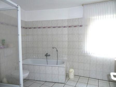 a white bathroom with a tub and a toilet at Hotel Klusenhof in Lippstadt
