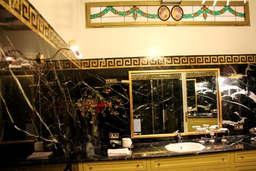 a bathroom with a sink and a mirror at Di Rienzo Pantheon Palace in Rome