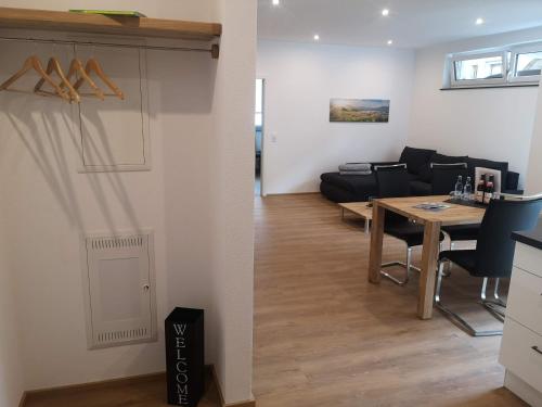a living room and a dining room with a table at Franzl Hof Zorell in Ravensburg