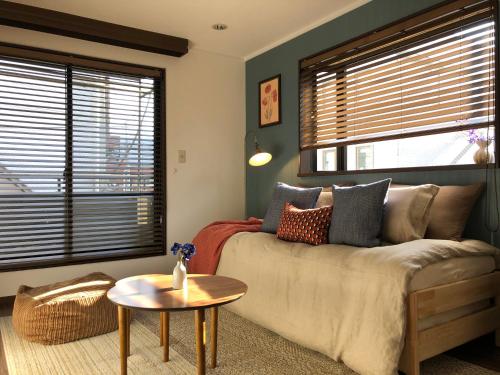 a living room with a couch and a table at LiveGRACE Hotel Shibuya 渋谷西新宿 in Tokyo