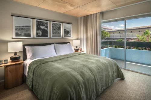 a bedroom with a large bed and a large window at PACIFIC 19 Kona in Kailua-Kona