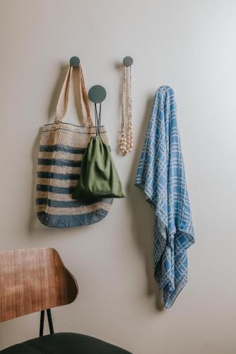 two towels and a purse hanging on a wall at PACIFIC 19 Kona in Kailua-Kona