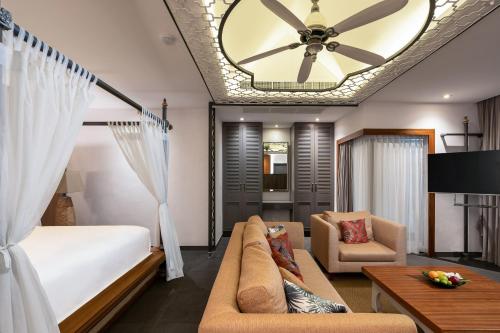 a bedroom with a bed and a ceiling fan at Dewa Phuket Resort & Villas, Nai Yang Beach in Nai Yang Beach