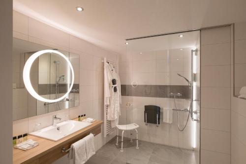 a bathroom with a sink and a shower at Hotel St. Wolfgang in Bad Griesbach