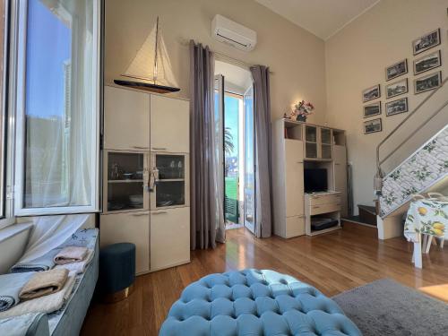 a living room with a couch and a large window at AL CASTELLO-VISTA MARE -ROMANTICO e CENTRALE a 20 METRI DAL MARE-toll parking at 15 euro per day to be booked in advance -subject to availability in Rapallo